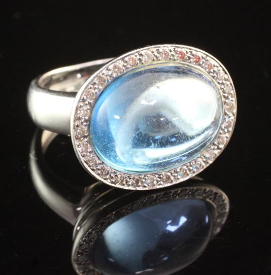 An 18ct white gold, diamond and cabochon blue topaz dress ring, size J.